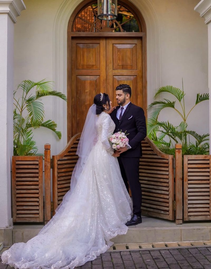 Couple at classical arched wooden doorway