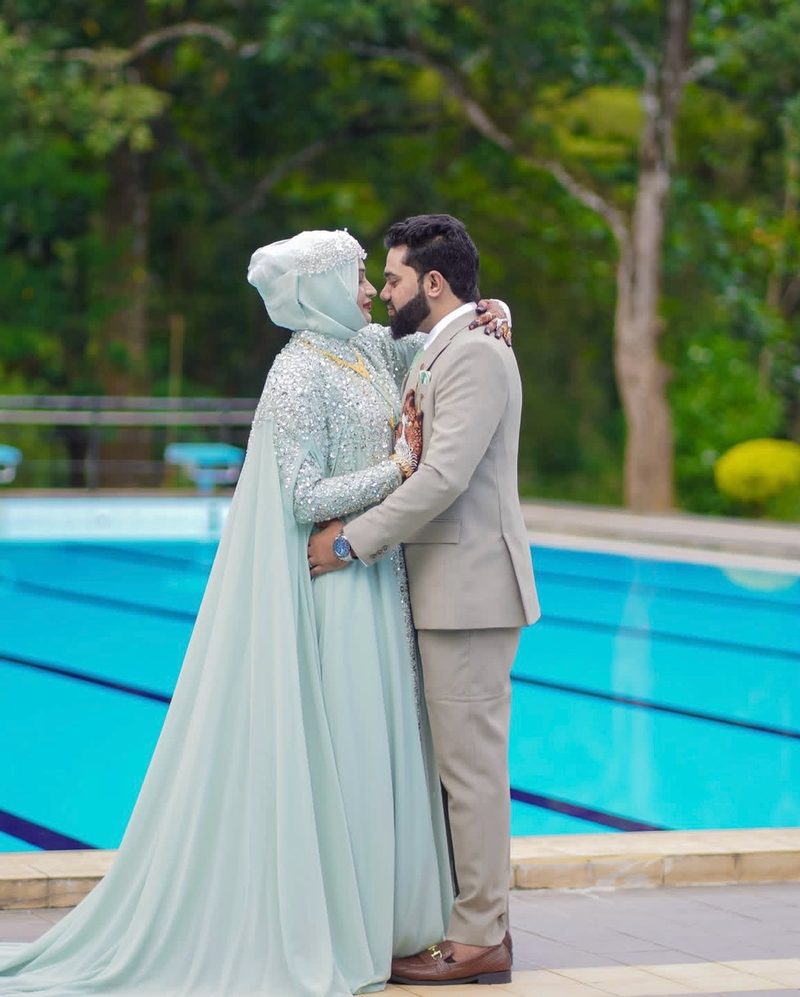 Couple in mint attire by the poolside
