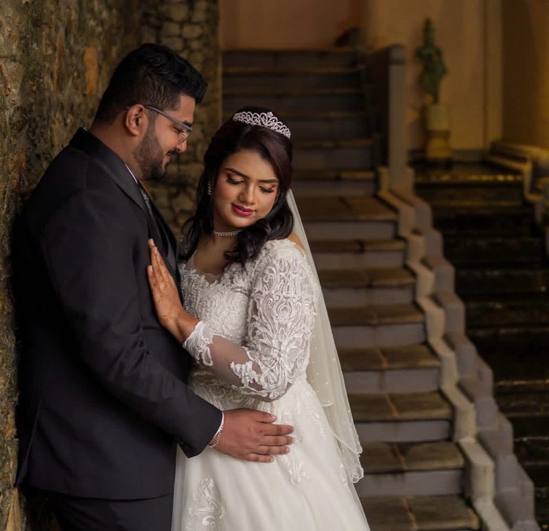 Bride with tiara and groom in romantic stairwell